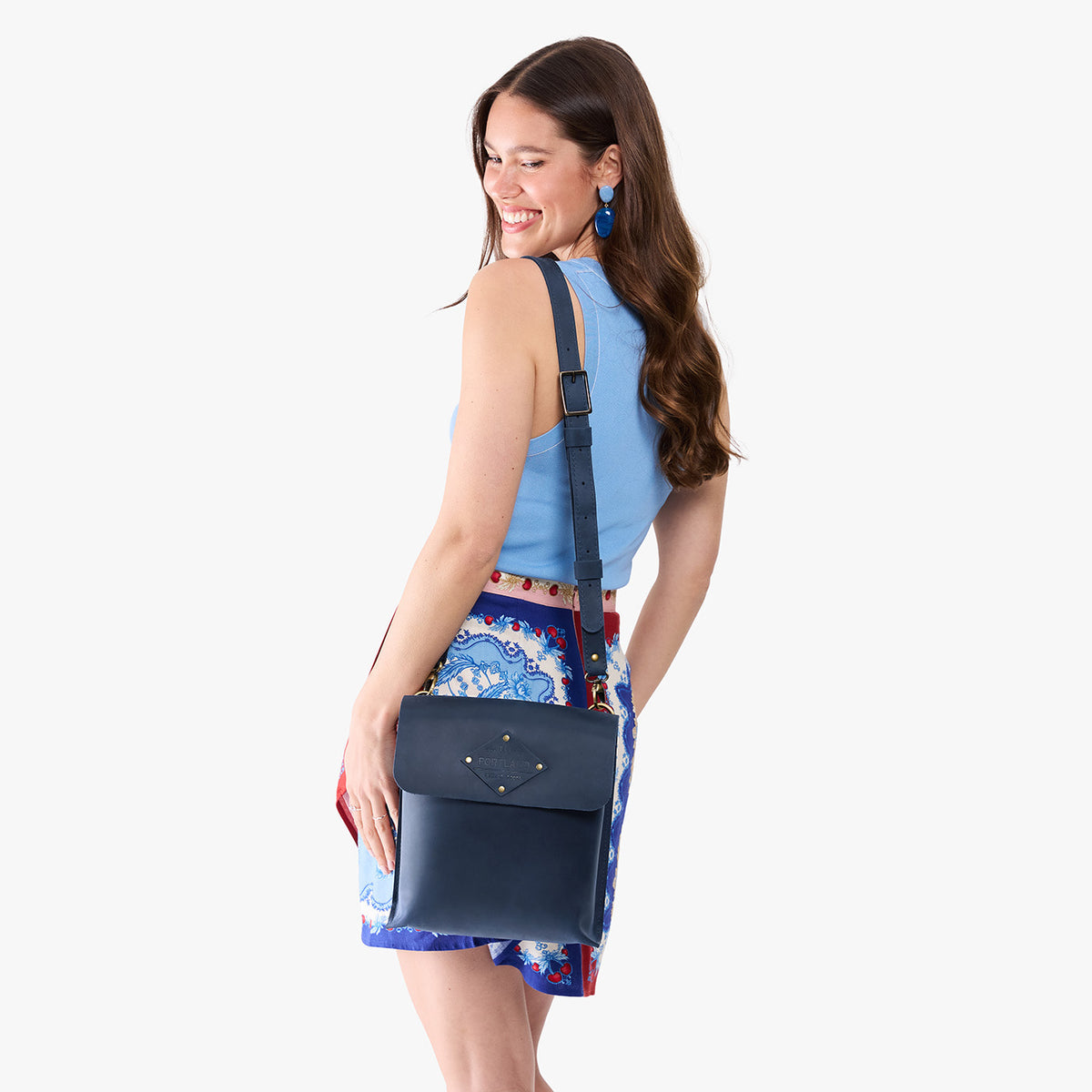 Deep Water | Model carrying slim satchel bag with crossbody strap and flap with magnet snap closure