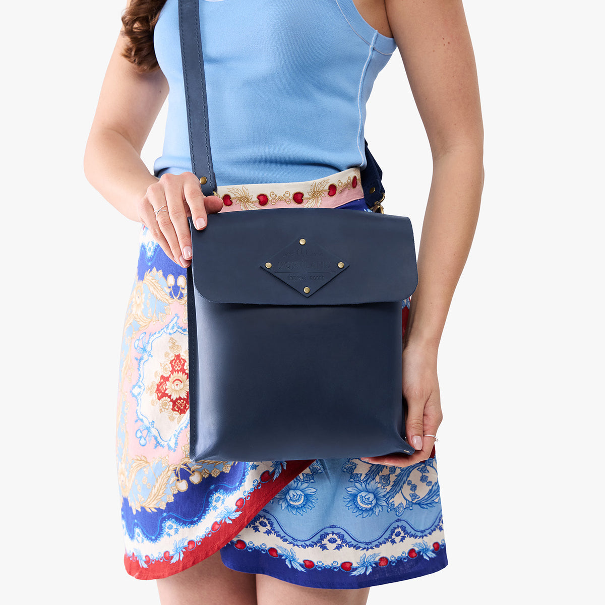 Deep Water | Model carrying slim satchel bag with crossbody strap and flap with magnet snap closure