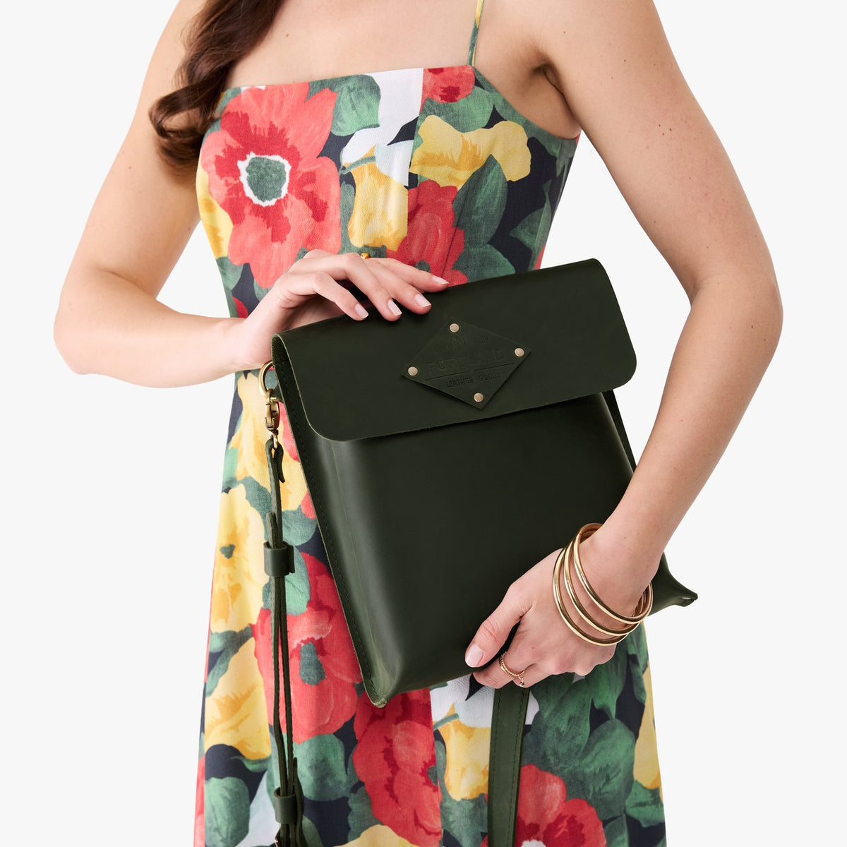 Evergreen | Model carrying slim satchel bag with crossbody strap and flap with magnet snap closure