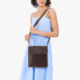 Moose | Model carrying slim satchel bag with crossbody strap and flap with magnet snap closure