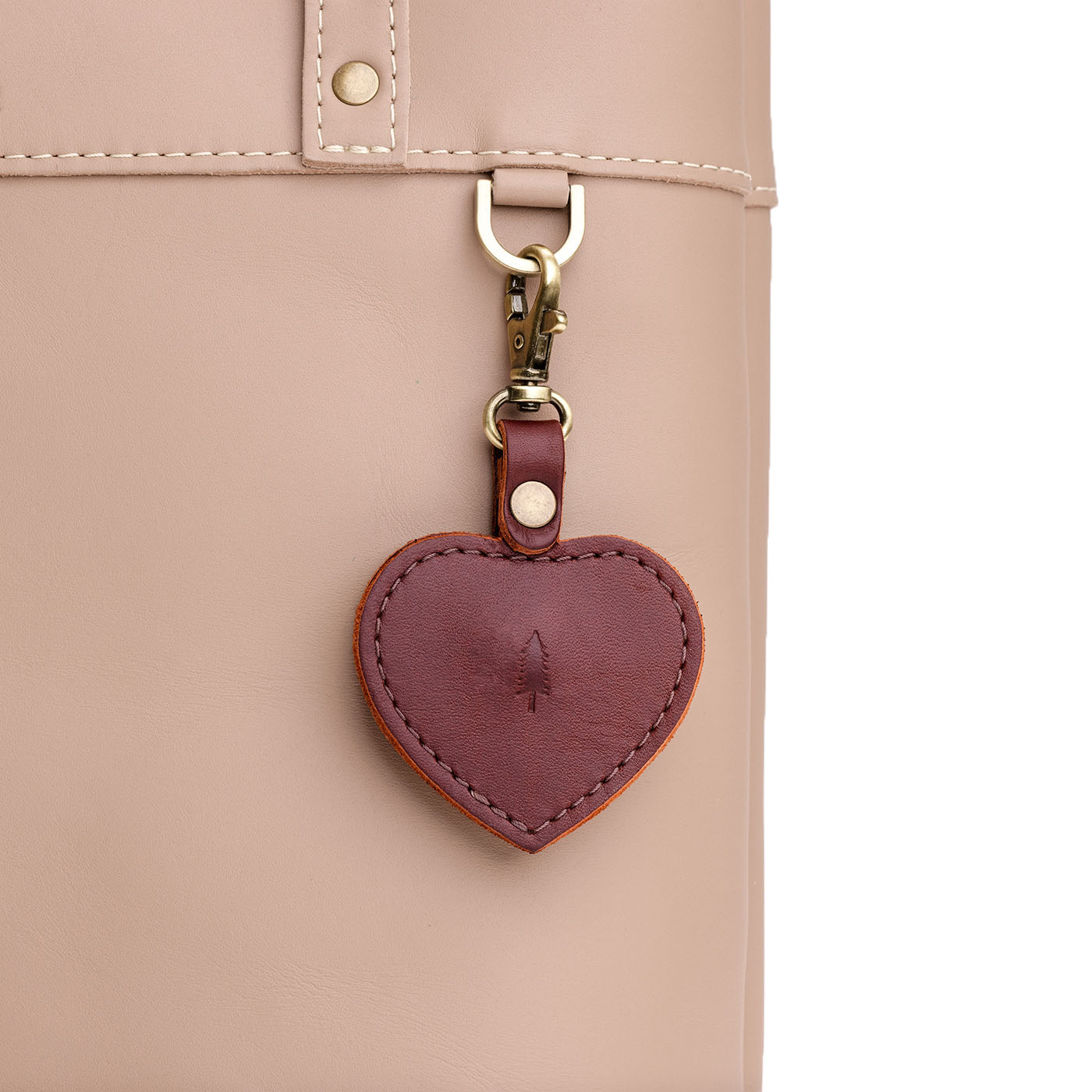 Cognac | Heart-shaped airtag holder keychain with a swivel lobster clasp on bag