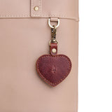 Nutmeg | Heart-shaped airtag holder keychain with a swivel lobster clasp on bag