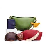 All Color: 1 Koala + 6 Items | Koala Sling Bag in Cactus next to Mini Bifold Wallet, Mockingbird Pouch, Taco Tassel Pouch, Petunia Pouch, Eclipse Purse, and a Jumbo Leather Tassel