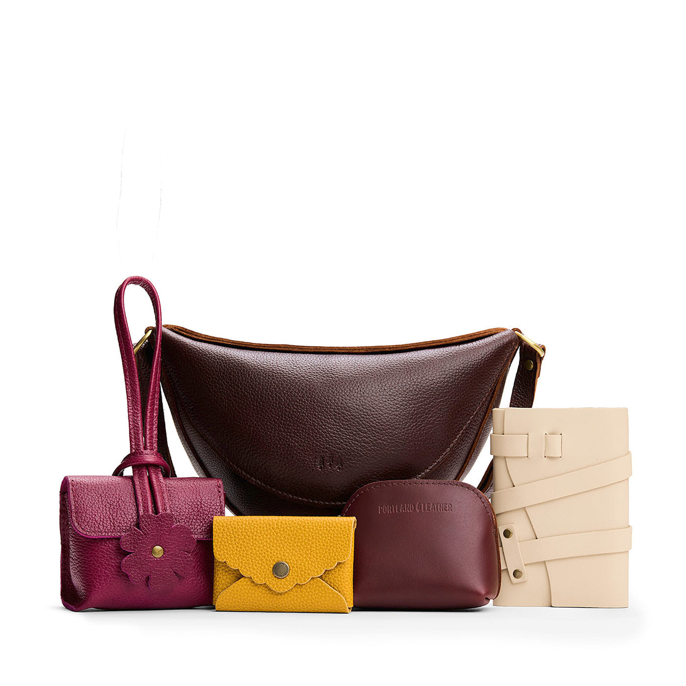All Color: 1 Koala + 4 Items | Koala Sling Bag in Coldbrew next to Blooming Wristlet, Daisy Plus Wallet, Luna Pouch, and a Wrap Journal