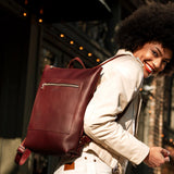 All Color: Cognac | Model wearing rectangular slim leather backpack
