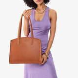 Honey Large | Model carrying leather tote bag with handles, adjustable crossbody strap, and two back pockets