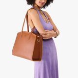 Honey Large | Model carrying leather tote bag with handles, adjustable crossbody strap, and two back pockets