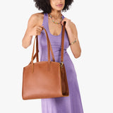 Honey Large | Model carrying leather tote bag with handles, adjustable crossbody strap, and two back pockets
