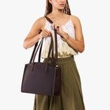 Moose Large | Model carrying leather tote bag with handles, adjustable crossbody strap, and two back pockets