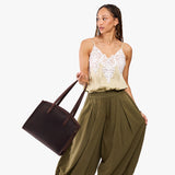 Moose Large | Model carrying leather tote bag with handles, adjustable crossbody strap, and two back pockets