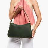 Evergreen Large | Model holding a bean shaped shoulder bag with a zipper closure