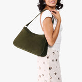 Verdant Large | Model holding a bean shaped shoulder bag with a zipper closure