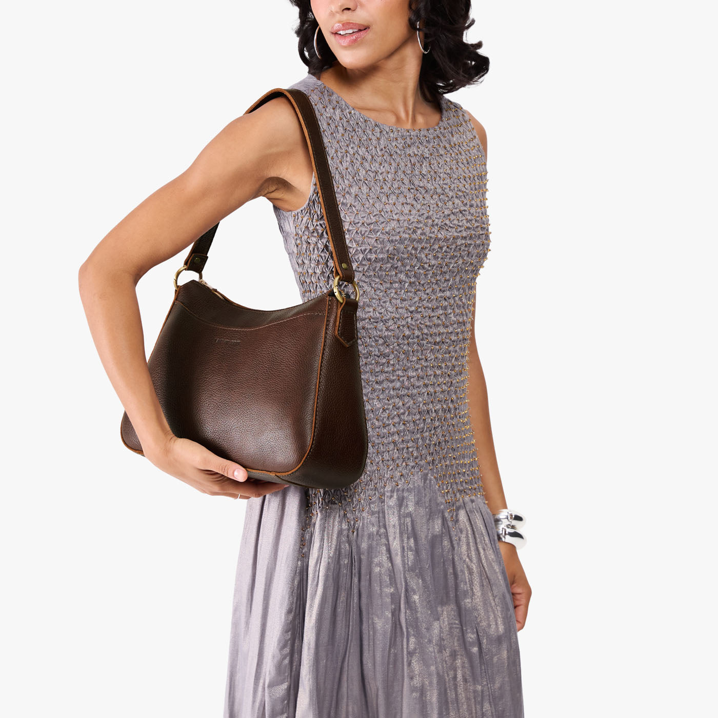 Coldbrew*Large | Model holding a bean shaped shoulder bag with a zipper closure