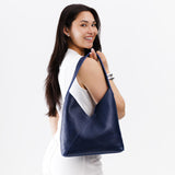 Cobalt Large | Model wearing mid-size shoulder bag with magnetic snap closure