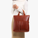 Nutmeg Large | Model wearing a convertible tote clutch crossbody