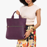Plum Large | Model wearing a convertible tote clutch crossbody