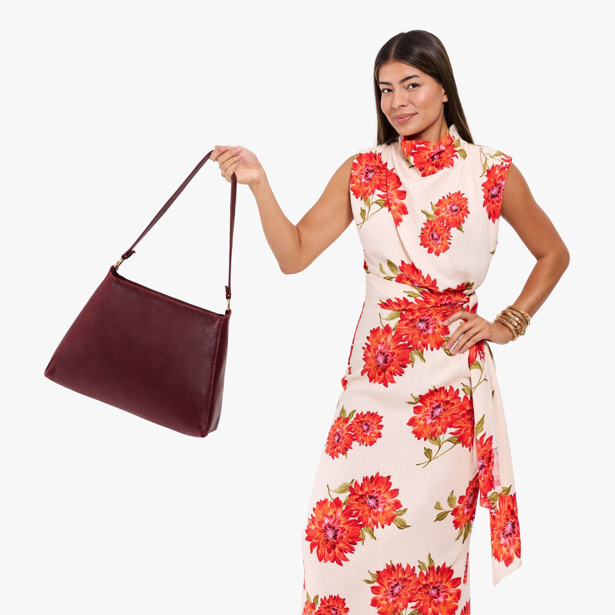 Cabernet*Large | Model holding a triangular shoulder bag with antiqued brass finished 