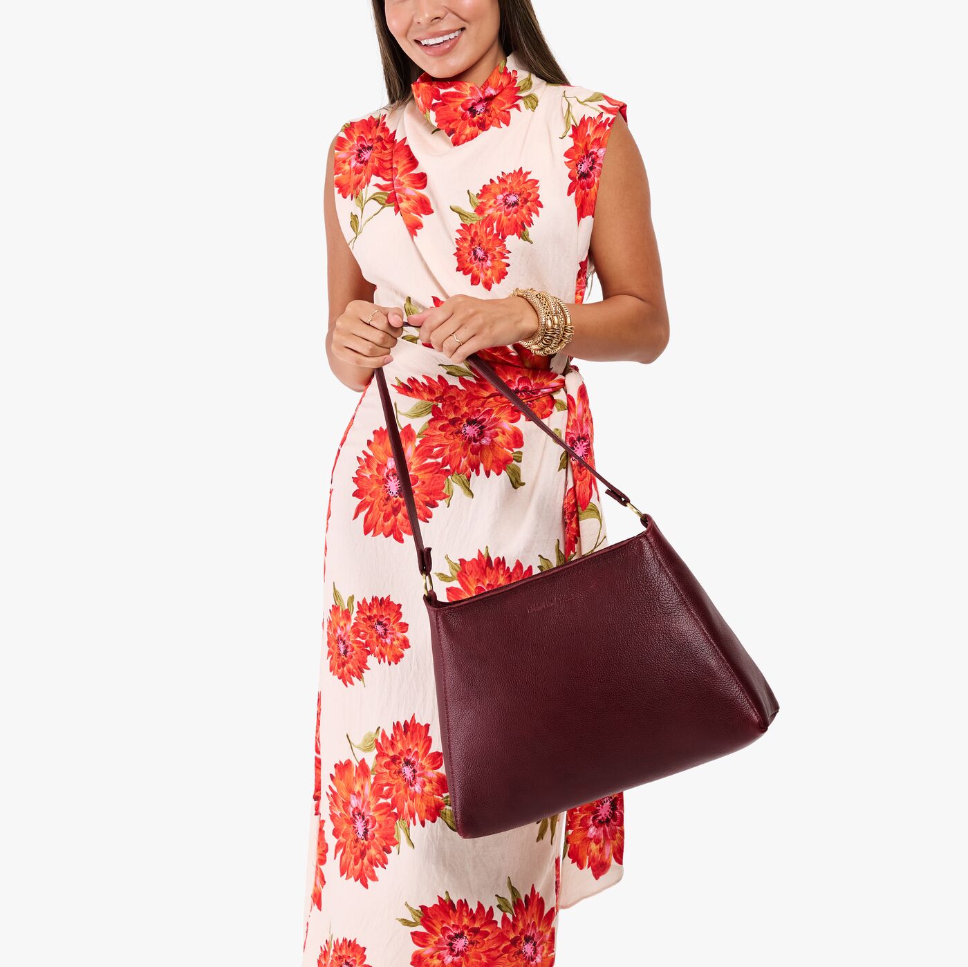 Cabernet*Large | Model holding a triangular shoulder bag with antiqued brass finished 