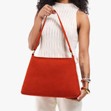Paprika Large | Model holding a triangular shoulder bag with antiqued brass finished 