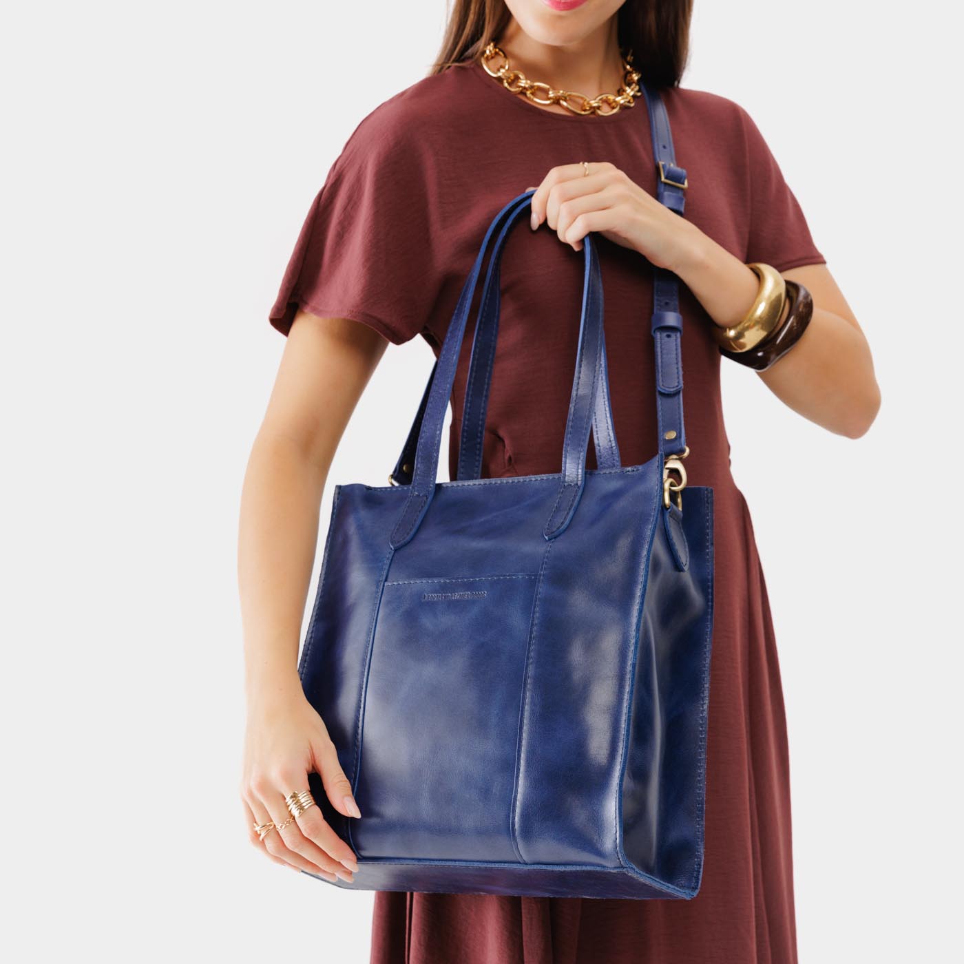 Cowboy Blue*North/South | Model wearing structured large tote bag with overlapping panels and crossbody strap