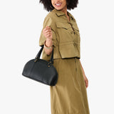 Black Small | Model holding a half circle crossbody bag with handles and removable crossbody strap 