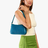 Planetary Small | Model carrying petite bean shaped shoulder bag with a zipper closure