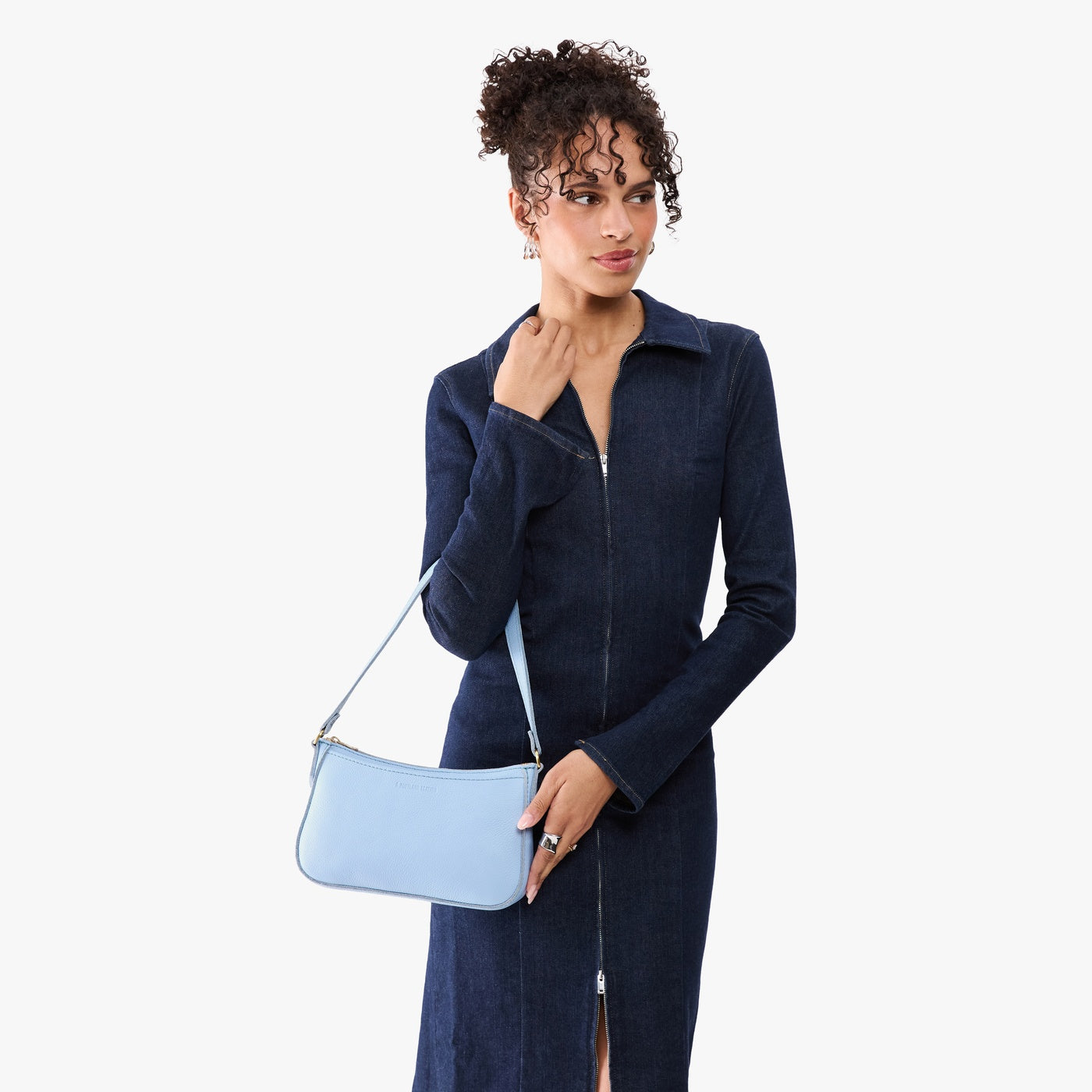 Skyway | Model carrying petite bean shaped shoulder bag with a zipper closure
