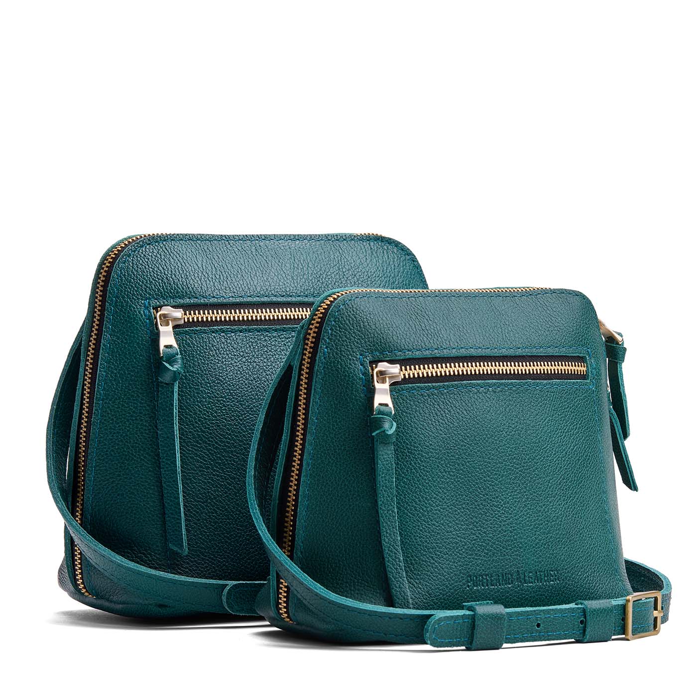 Sea Glass | Comparison image of small and medium-sized compact leather bags with top zipper, front zipper pocket, and adjustable crossbody strap