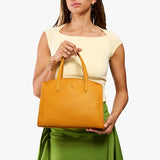 Sunshine Medium | Model carrying leather tote bag with handles, adjustable crossbody strap, and two back pockets