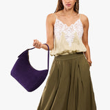 Imperial Medium | Model holding u-shaped, flat-bottomed leather shoulder bag with adjustable strap