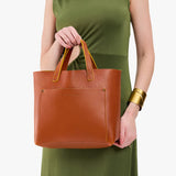 Sienna Classic | Model holding midsize crossbody tote with handles and a pocket