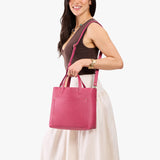Wild Rose Classic | Model holding midsize crossbody tote with handles and a pocket
