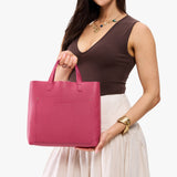 Wild Rose Classic | Model holding midsize crossbody tote with handles and a pocket