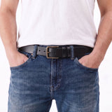 Jet Black | A model wearing a mens leather belt with two belt loops and antiqued brass buckle