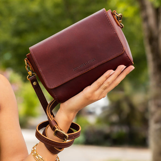 Cognac Metro Crossbody in outdoor setting. featured image