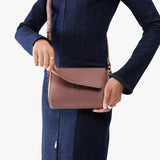 Sunkissed Mini | Model holding Small Leather Crossbody Bag with Magnetic Messenger Bag Closure