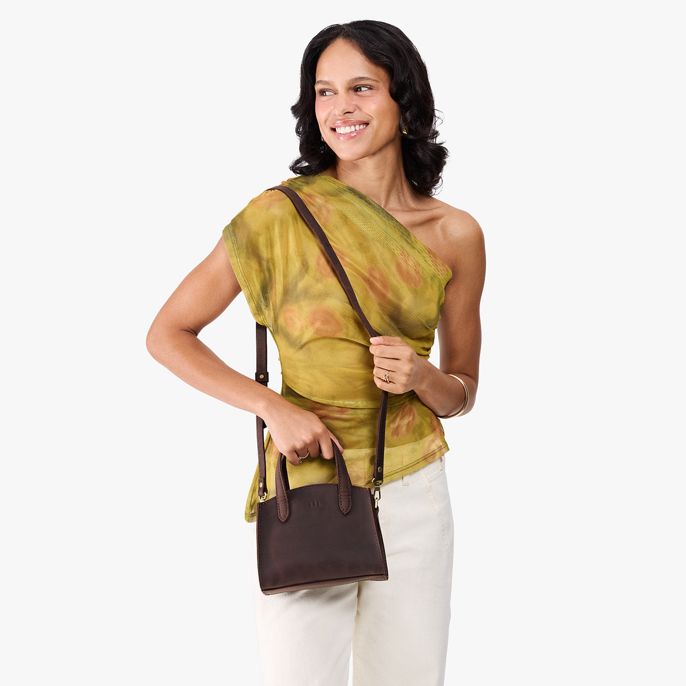 Moose*Mini | Model carrying small leather tote bag with handles, adjustable crossbody strap, and one back pocket