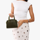 Pebbled Olive Mini | Model carrying small leather tote bag with handles, adjustable crossbody strap, and one back pocket