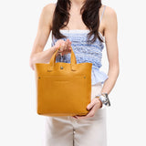 Sunshine Classic | Model carrying crossbody tote bag with snap closure and front pocket