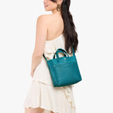 Aquarius Classic | Model wearing crossbody tote bag with snap closure and front pocket