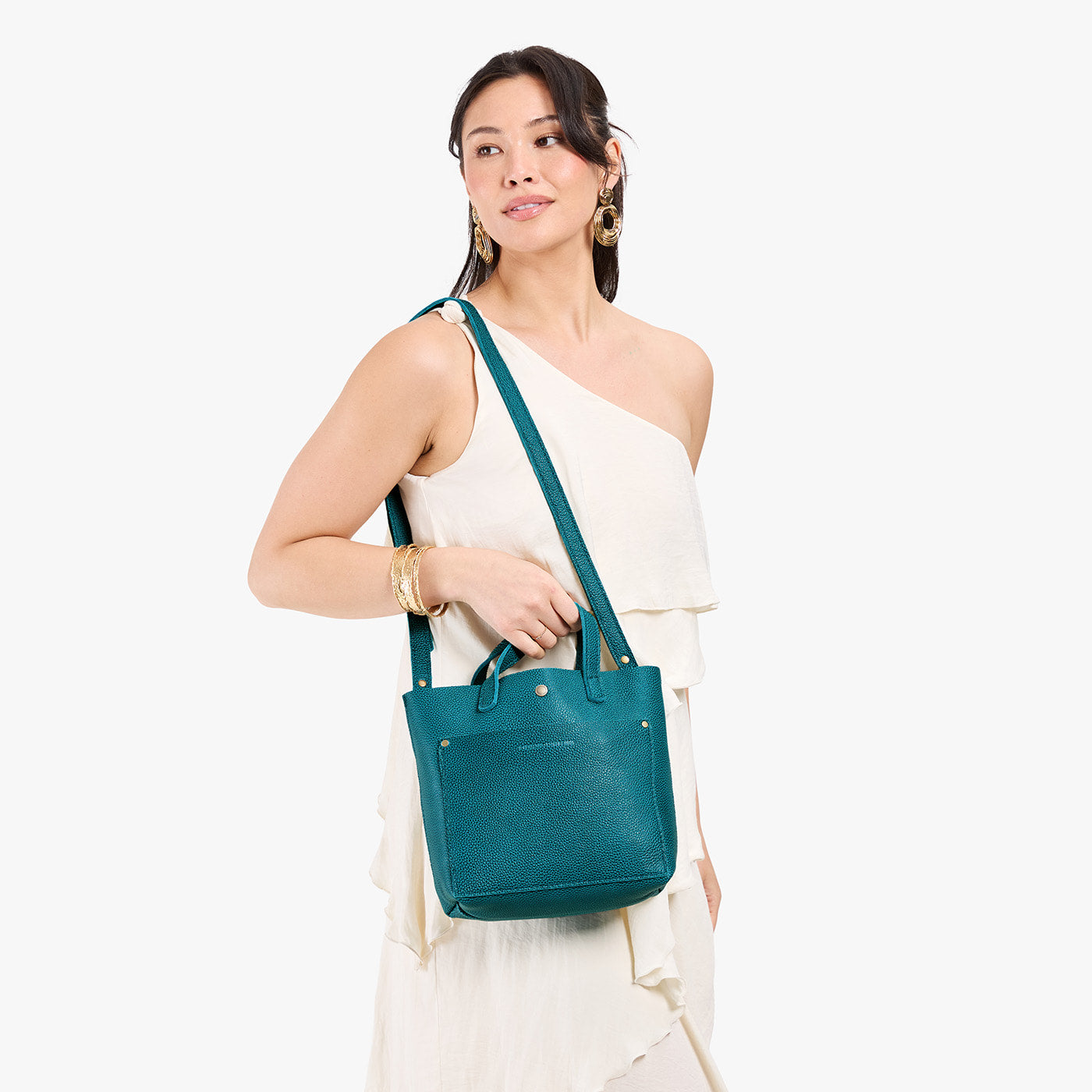 Aquarius*Classic | Model holding crossbody tote bag with snap closure and front pocket