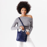 Cobalt Classic | Model wearing crossbody tote bag with snap closure and front pocket