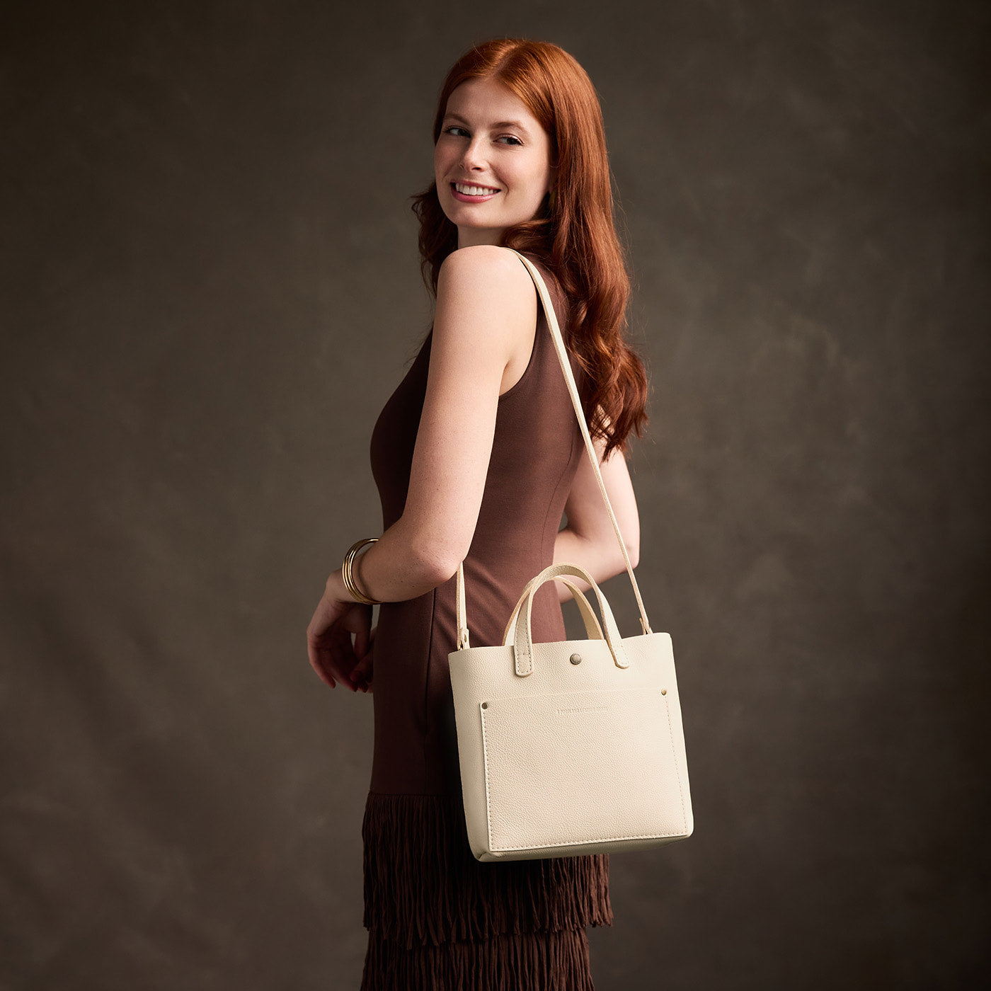 Pebbled Bone*Classic | Model carrying crossbody tote bag with snap closure and front pocket