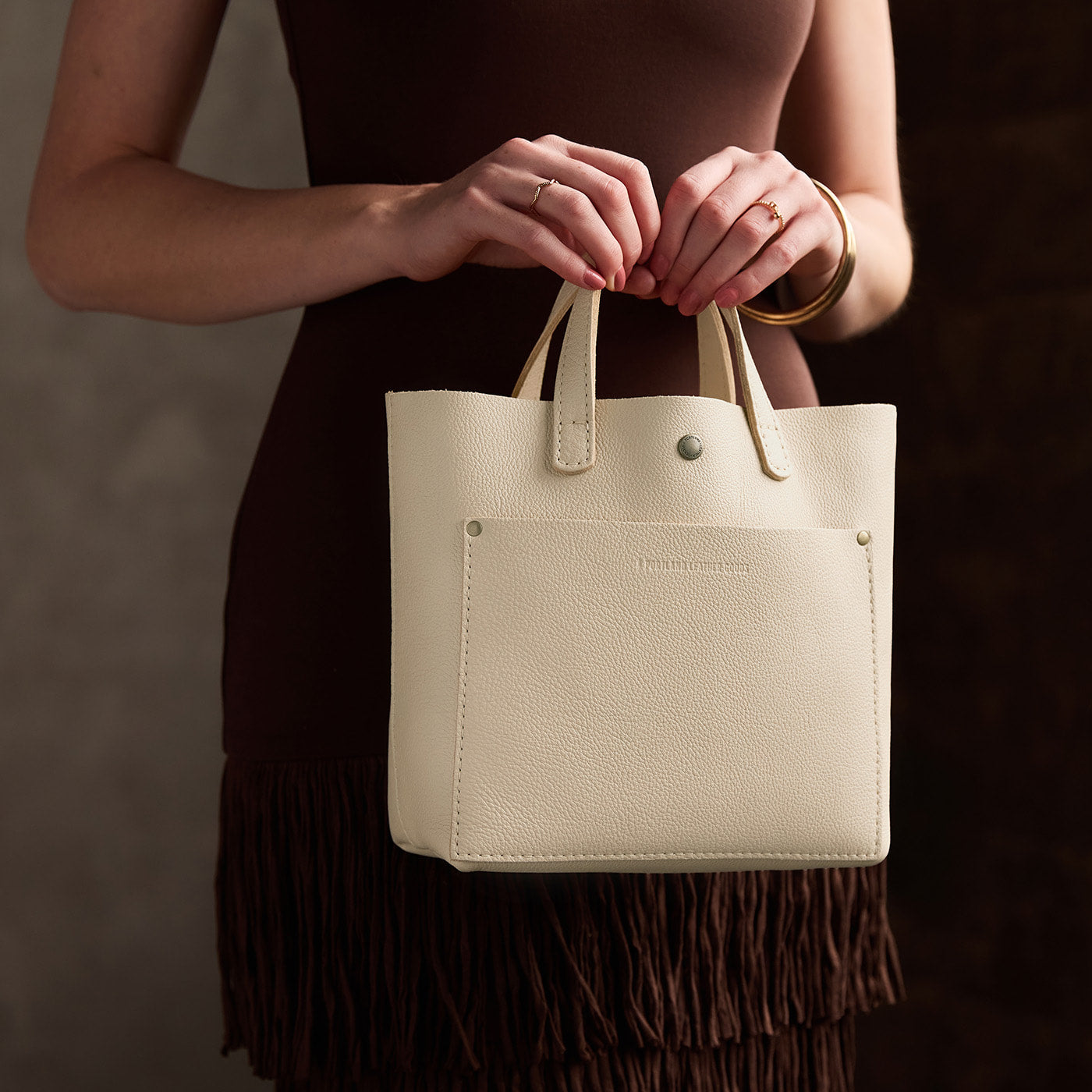 Pebbled Bone*Classic | Model carrying crossbody tote bag with snap closure and front pocket