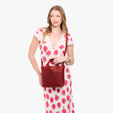 Phoenix Classic | Model holding crossbody tote bag with snap closure and front pocket