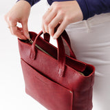 Chili Red Zipper | Model holding crossbody tote bag with zipper closure and front pocket