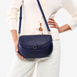 Cobalt Large | Model wearing a leather Crossbody with a flap and magnetic closure