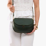 Evergreen Large | Model wearing a leather Crossbody with a flap and magnetic closure