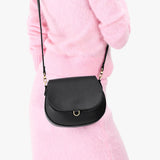 Black Small | Model wearing a petite leather Crossbody with a flap and magnetic closure