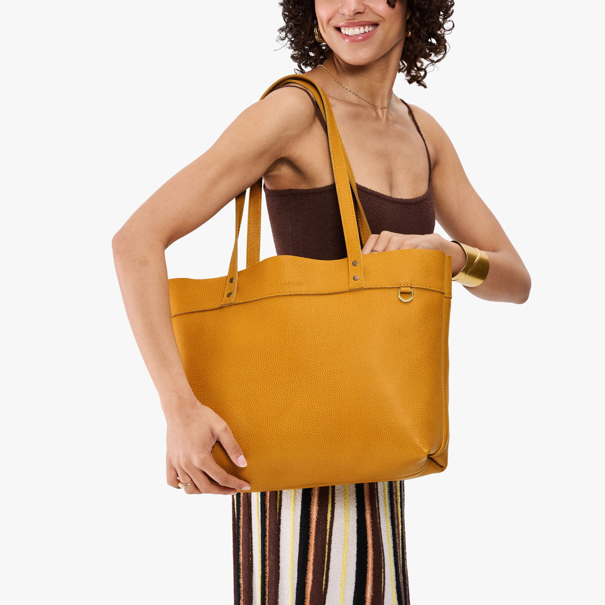 All Variants | Model holding Large Montana Tote in sunshine 